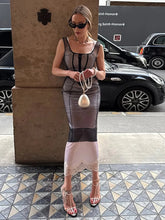 Woman in a stylish outfit standing on a city street with cars in the background